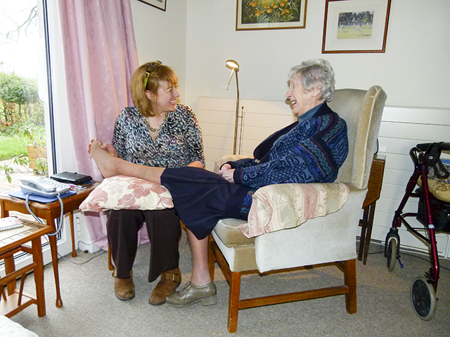 Caroline treating a patient at home